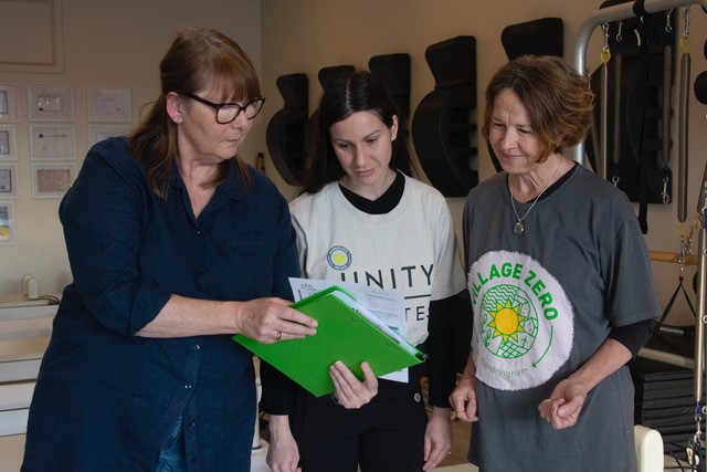 Danielle from Green Moves sharing the report from energy assessment wiht Elisa Messina (Owner of Unity Pilates) and HElen Gibson (Village Zero). Photograph by Pauline Reynolds