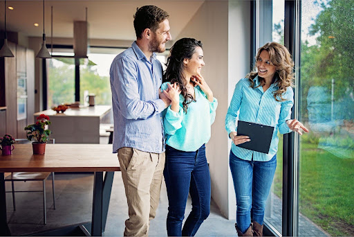 A sustainability consultant assessing a home’s efficiency with a couple before they purchase a property