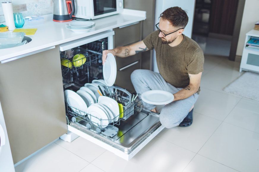 Man stacking the dishwasher