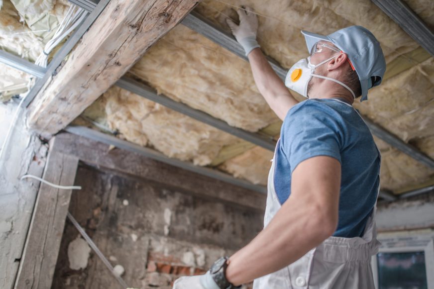 Tradie renovating installing insulation