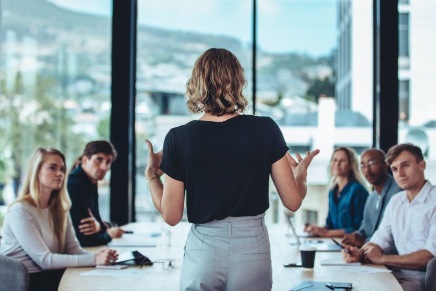 Woman speaking to a group of people in a boardroom