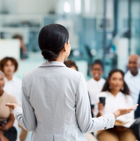 Rearview shot of an unrecognizable businesswoman giving a presentation in the office boardroom